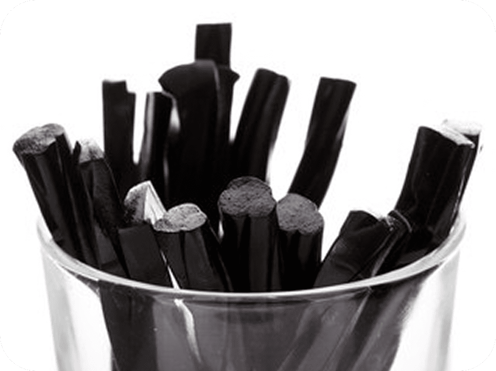 Licorice candy pieces upright in a cup
