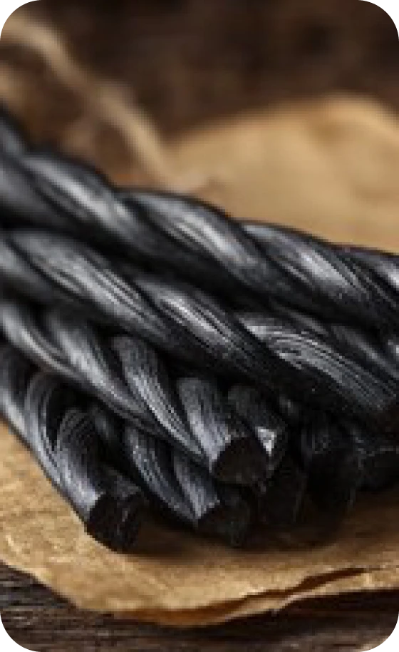 Black licorice sticks on brown paper