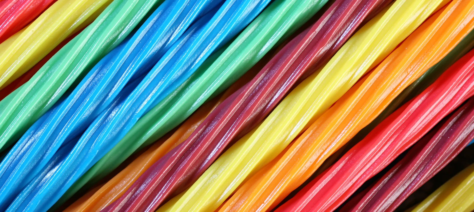 Brightly colored candy strands aligned