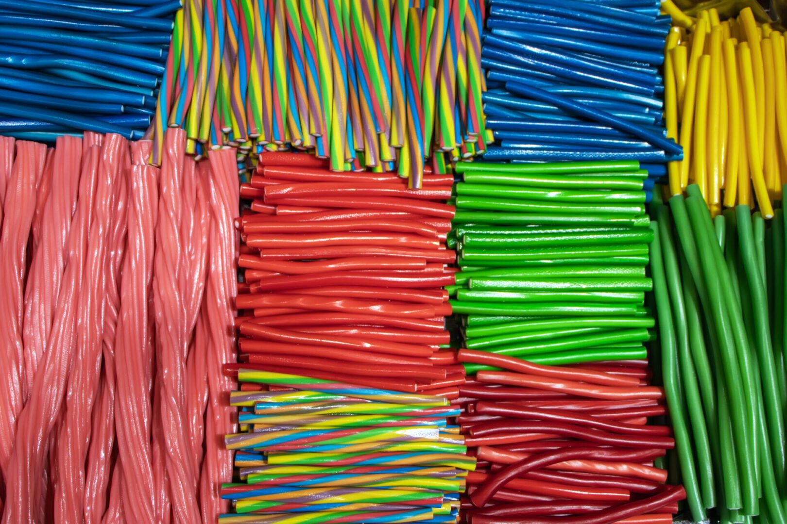 Colorful bundles of plastic tubes arranged by color.