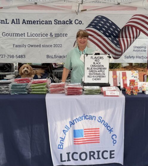 Vendor showcasing All American Snack Co. gourmet licorice and snacks.